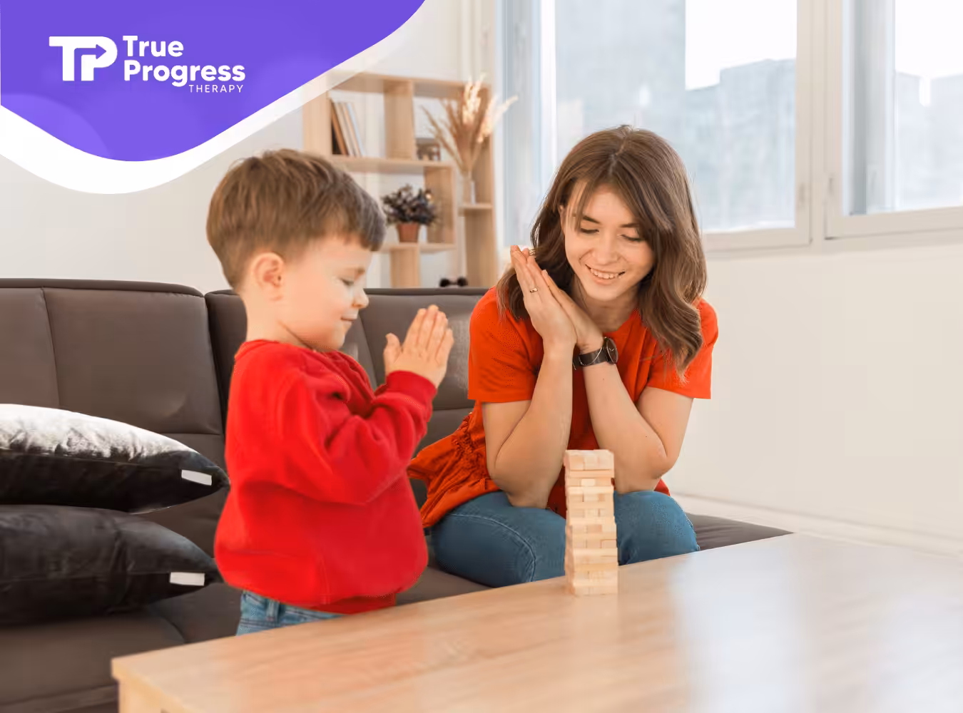 An kid with autism and his RBT are playing with wooden blocks
