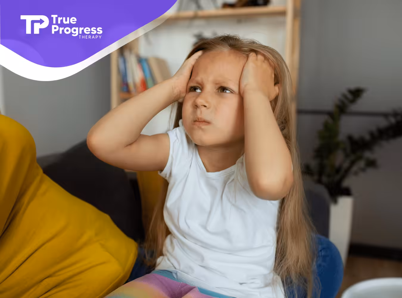 A kid with autism holding her head