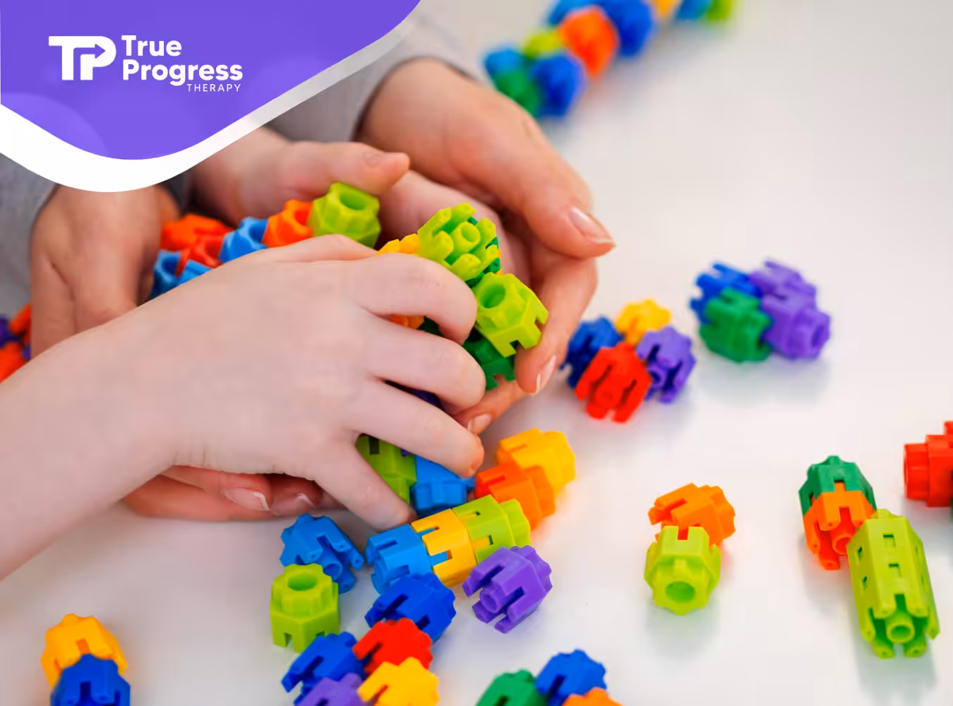 A boy with autism is playing with colorful toys