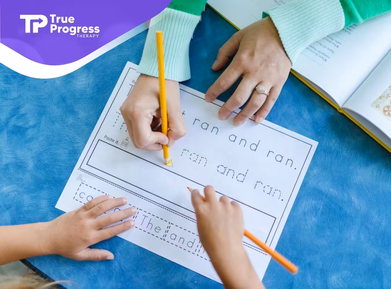 An autistic child and ABA therapist working on a handwriting worksheet together at a table in NJ.
