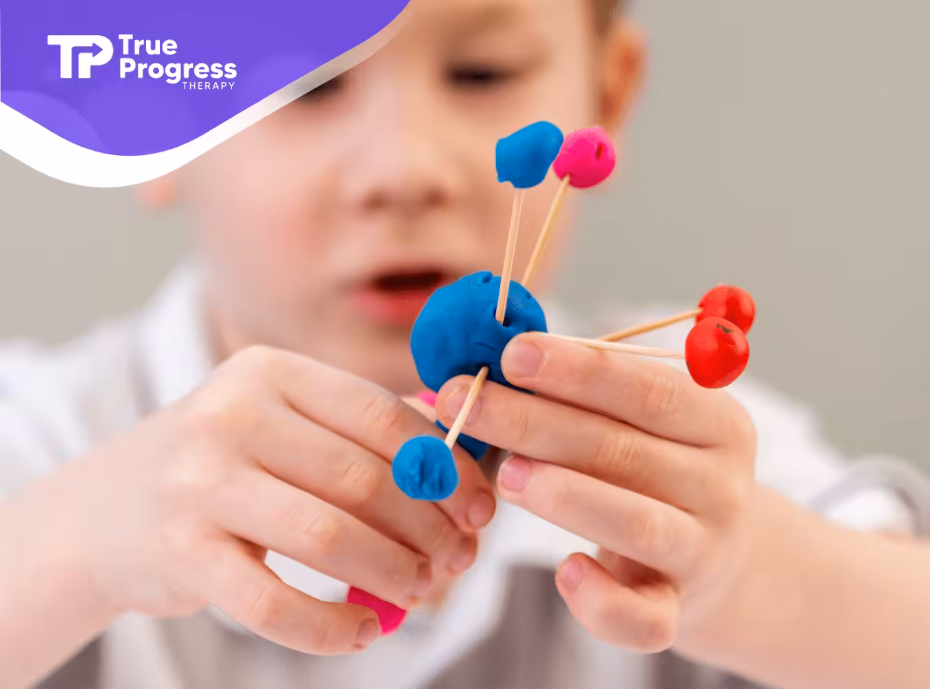A child with autism building a toy out of sensory materials