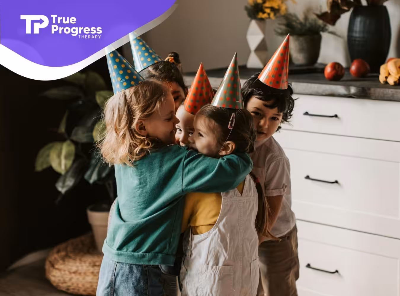Autistic children wearing party hats happily hugging during a birthday celebration indoors in New Jersey.