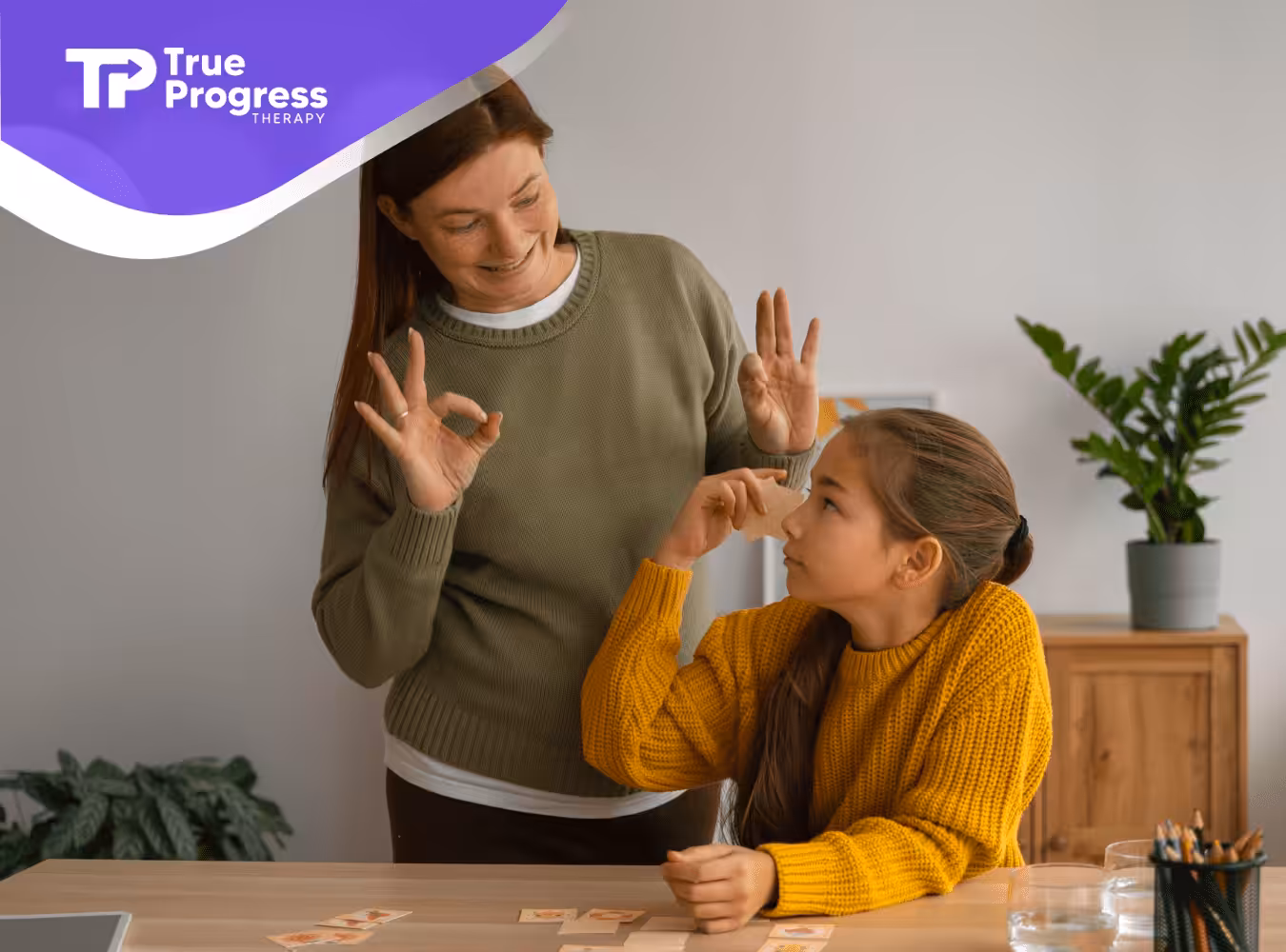 A little girl with autism is talking yo her mom using sign language