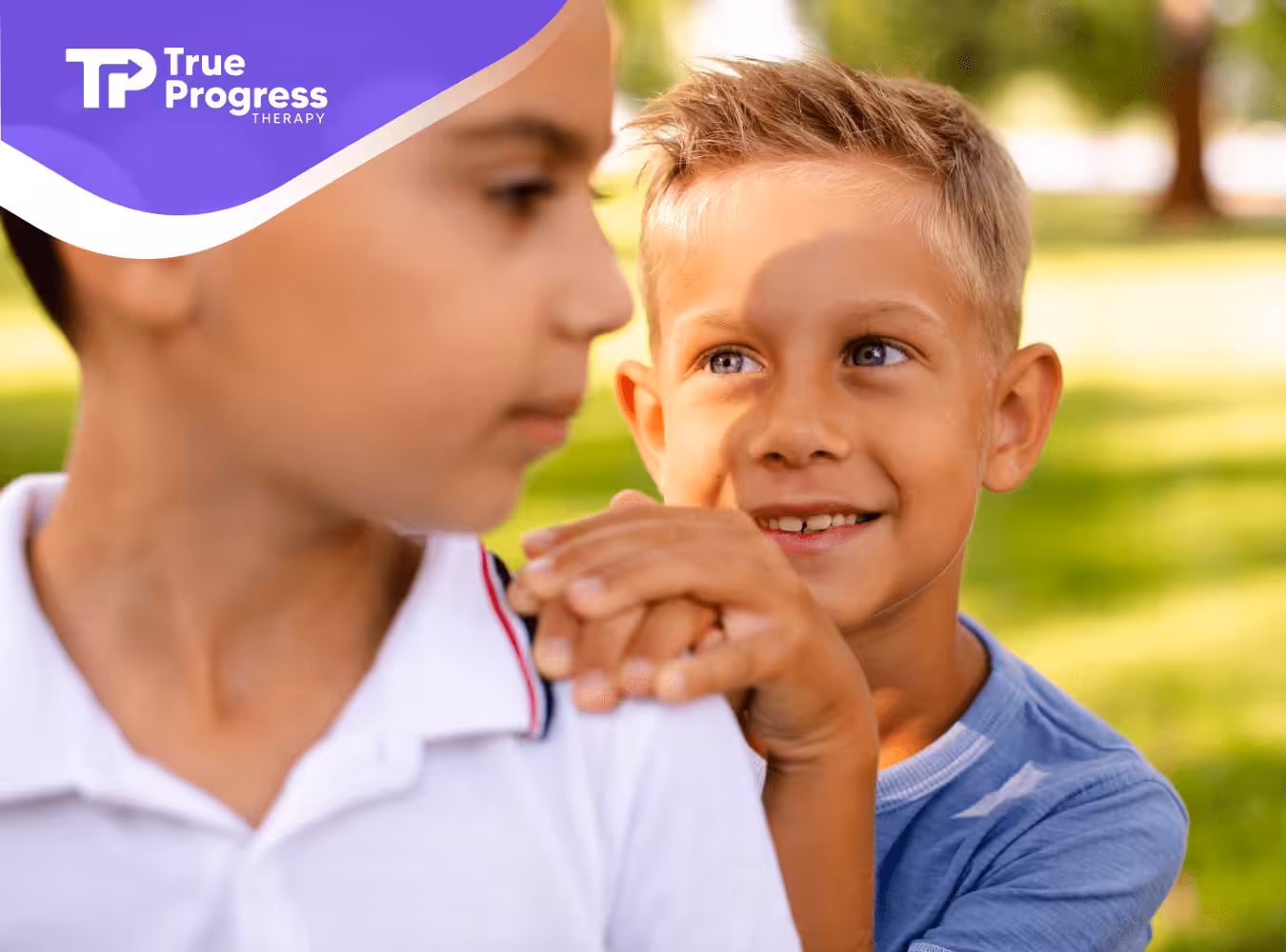 A child is looking at his friend with autism who's avoiding eye contact