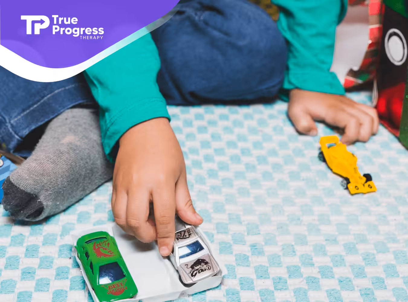 A kid with autism lining up his toy cars