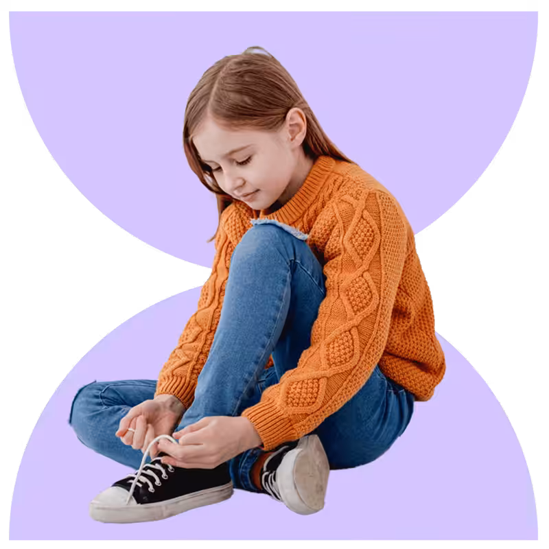 Child learning to tie their shoes