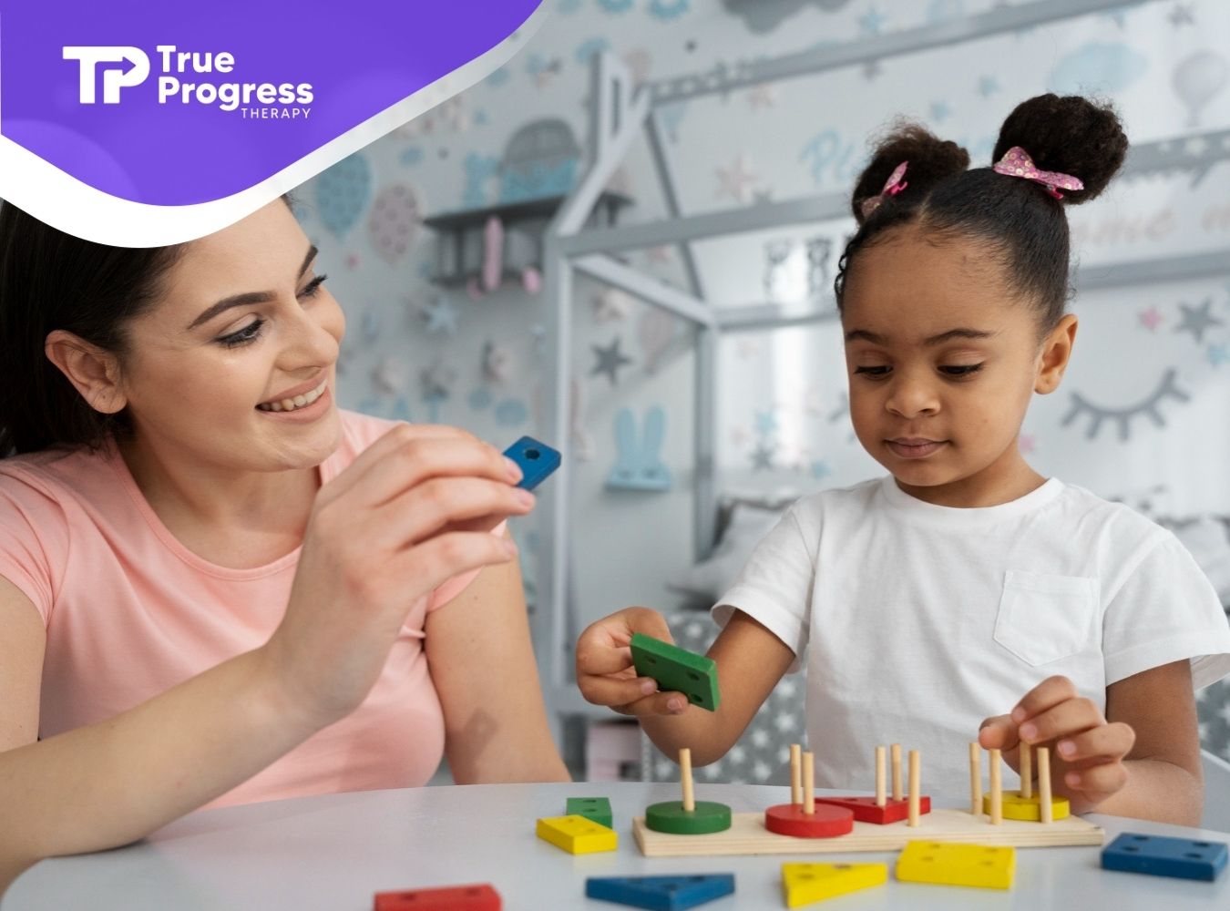 An ABA therapist and a girl learning shapes together through ABA therapy activities.