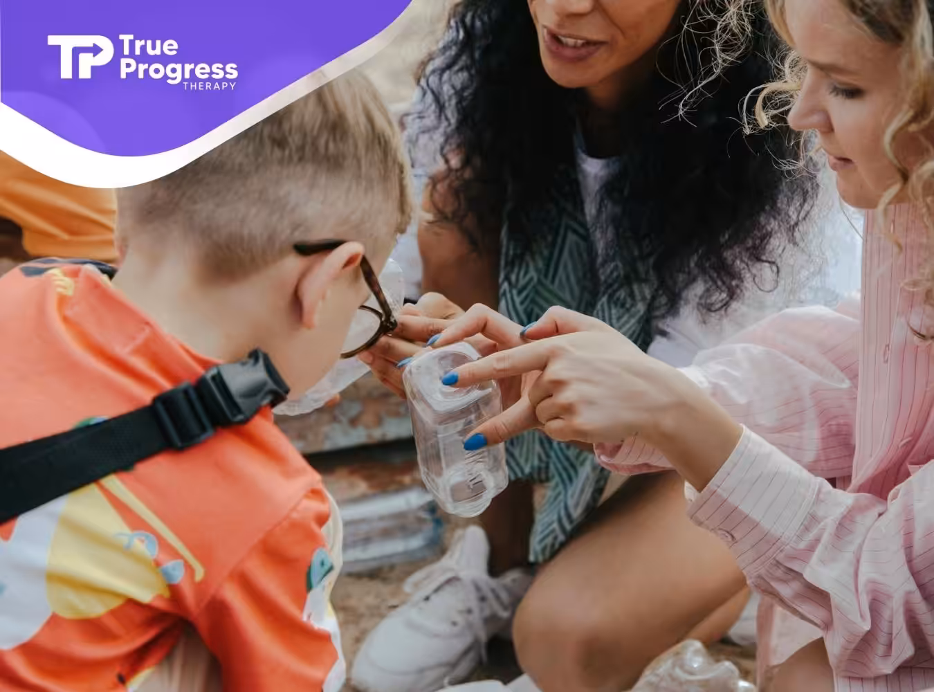 ABA therapist showing autistic boy an experiment with a plastic container during ABA therapy in NJ.