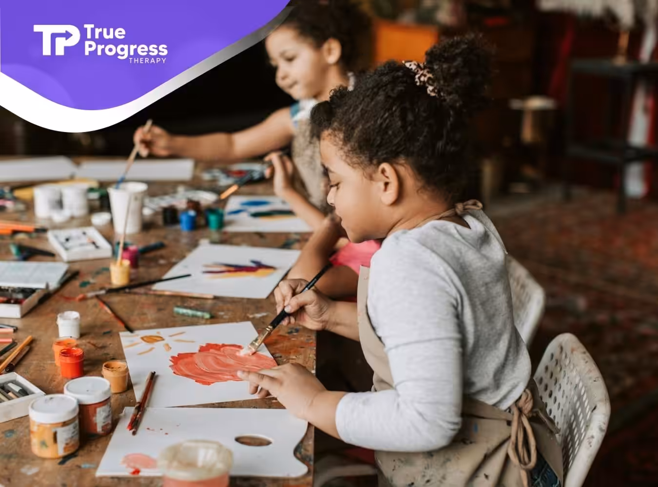Two children with autism painting with colors at a shared table during an art activity in NJ.