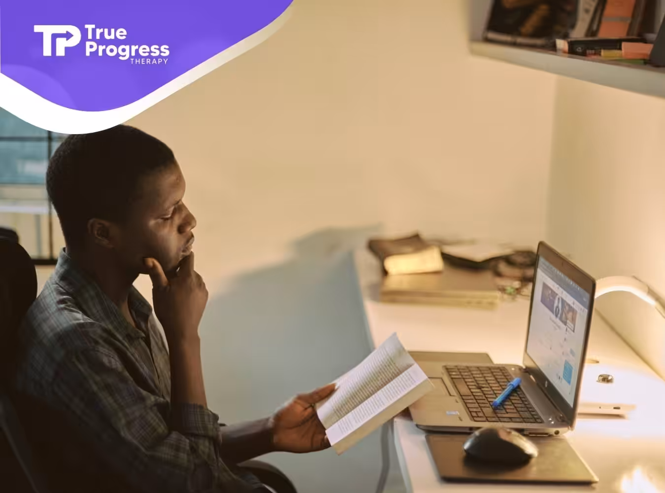 A BCBA aspirant sitting at a desk while studying for BCBA exam on his laptop at home in NJ.