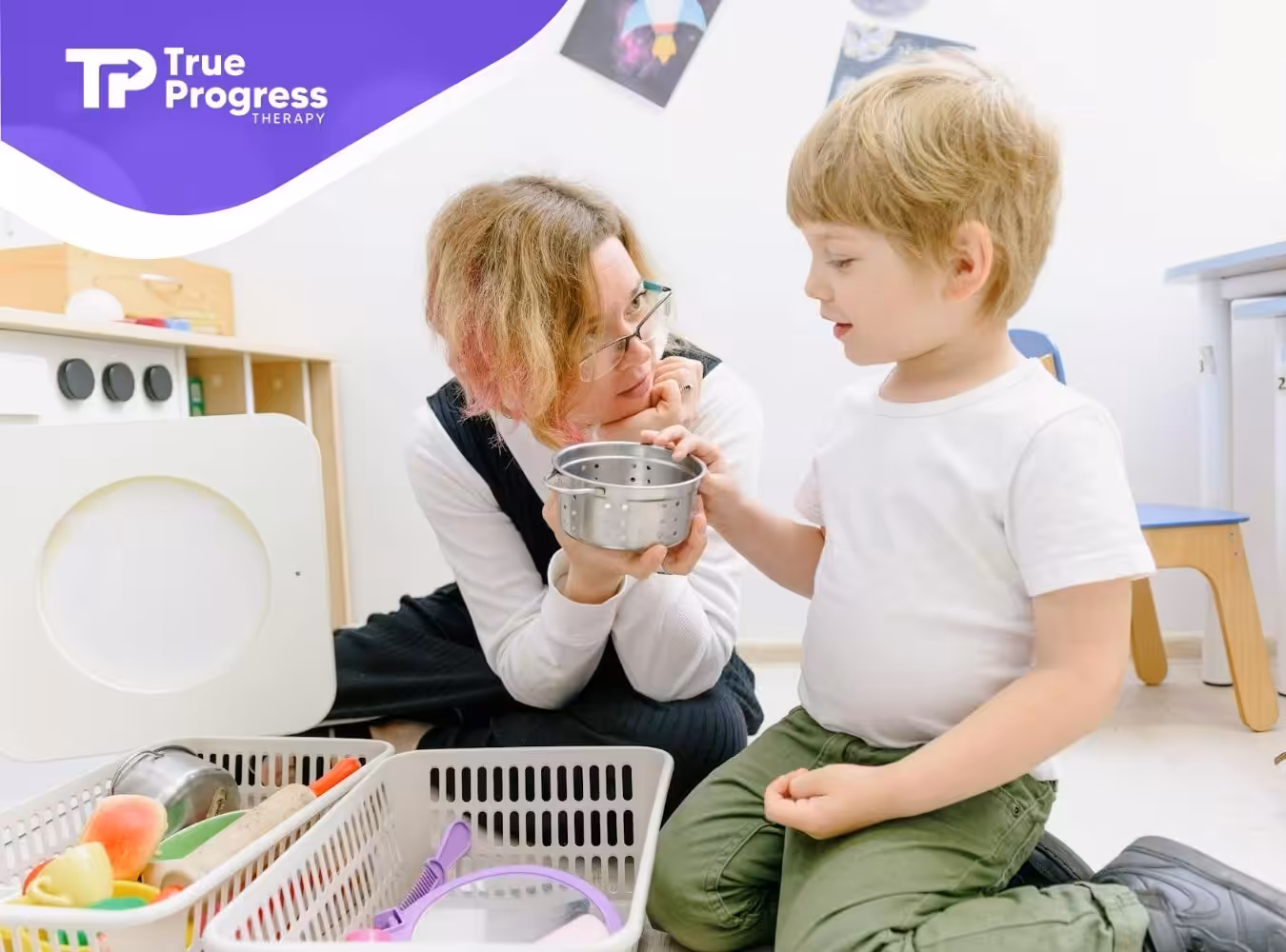 An RBT engaging with an autistic child while playing with kitchen toys at a classroom in New Jersey.