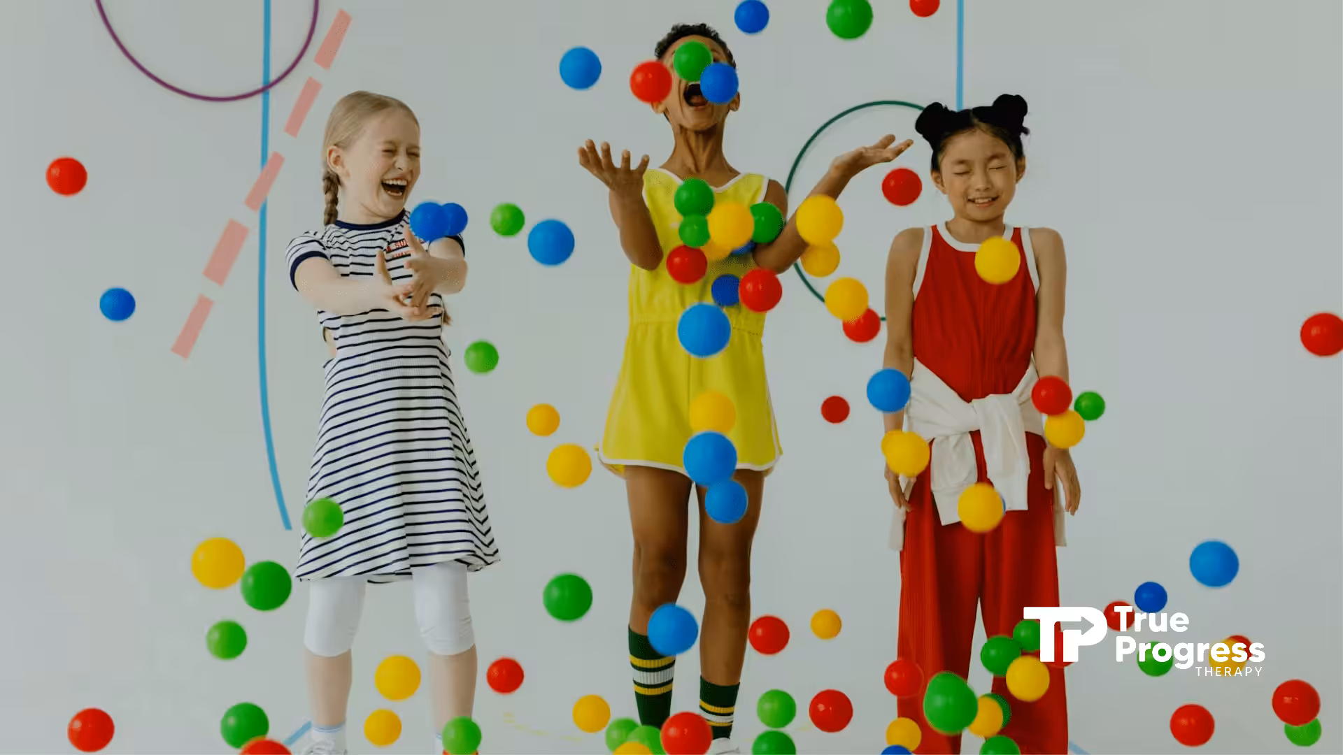 Three autistic kids joyfully playing with colorful plastic balls at a bright room in New Jersey.