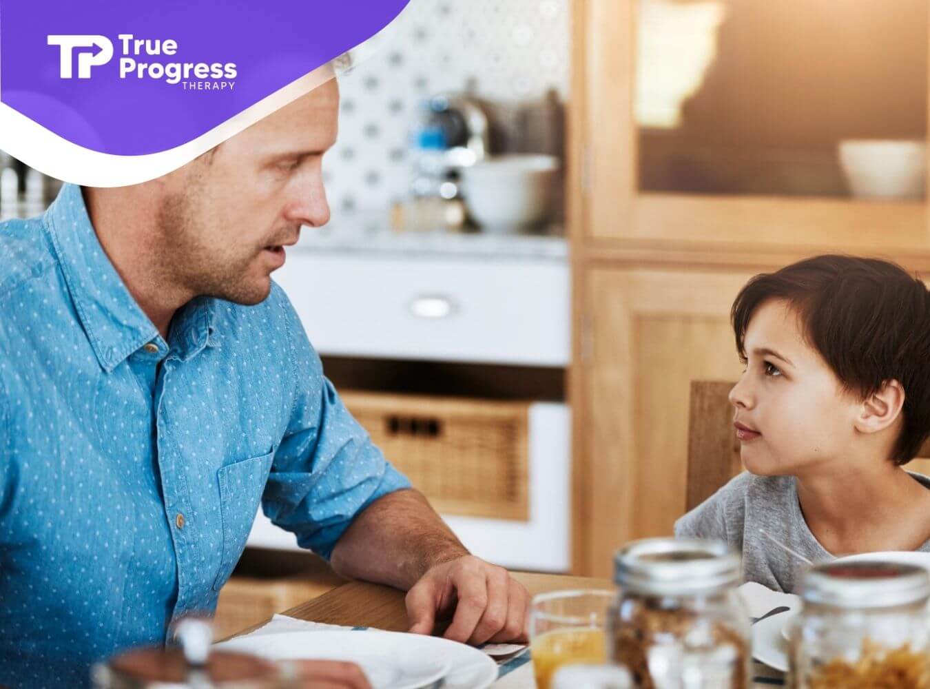 A BCBA explaining autism to a young child during ABA therapy.