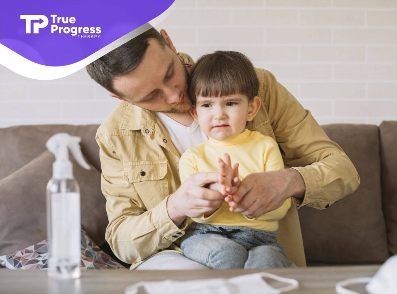BCBA helping a young child practice handwashing at home during in-home ABA therapy.