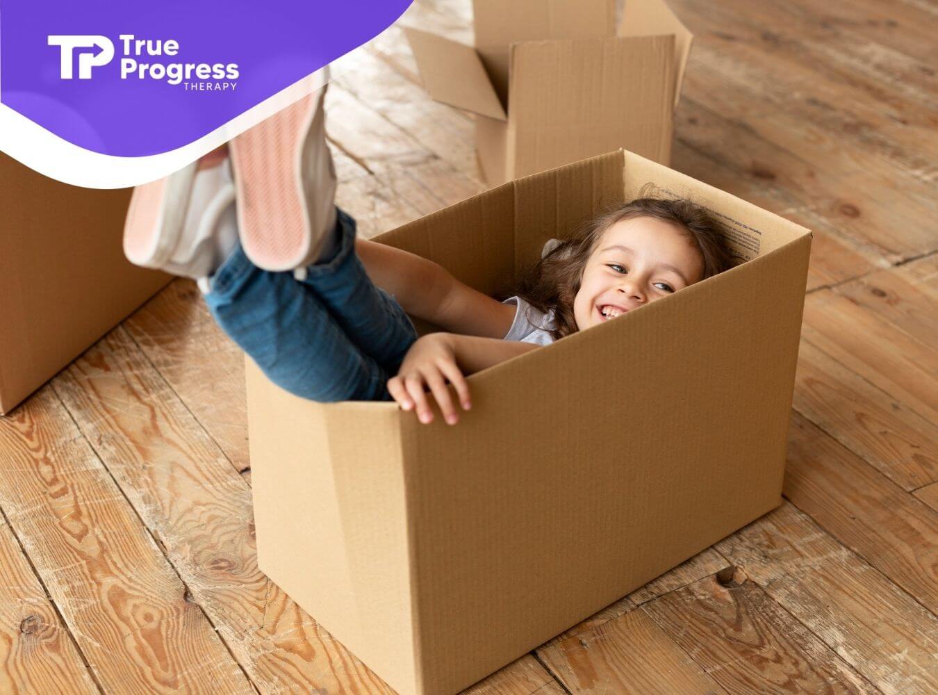 Child with autism playing inside cardboard box at home.