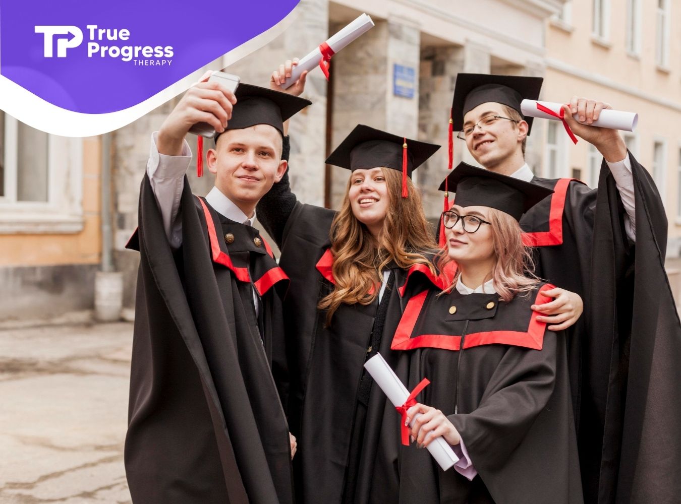 Four graduates with autism in caps and gowns taking a selfie outdoors while holding their diplomas.