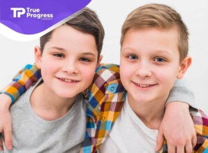 Two smiling children representing autism support.